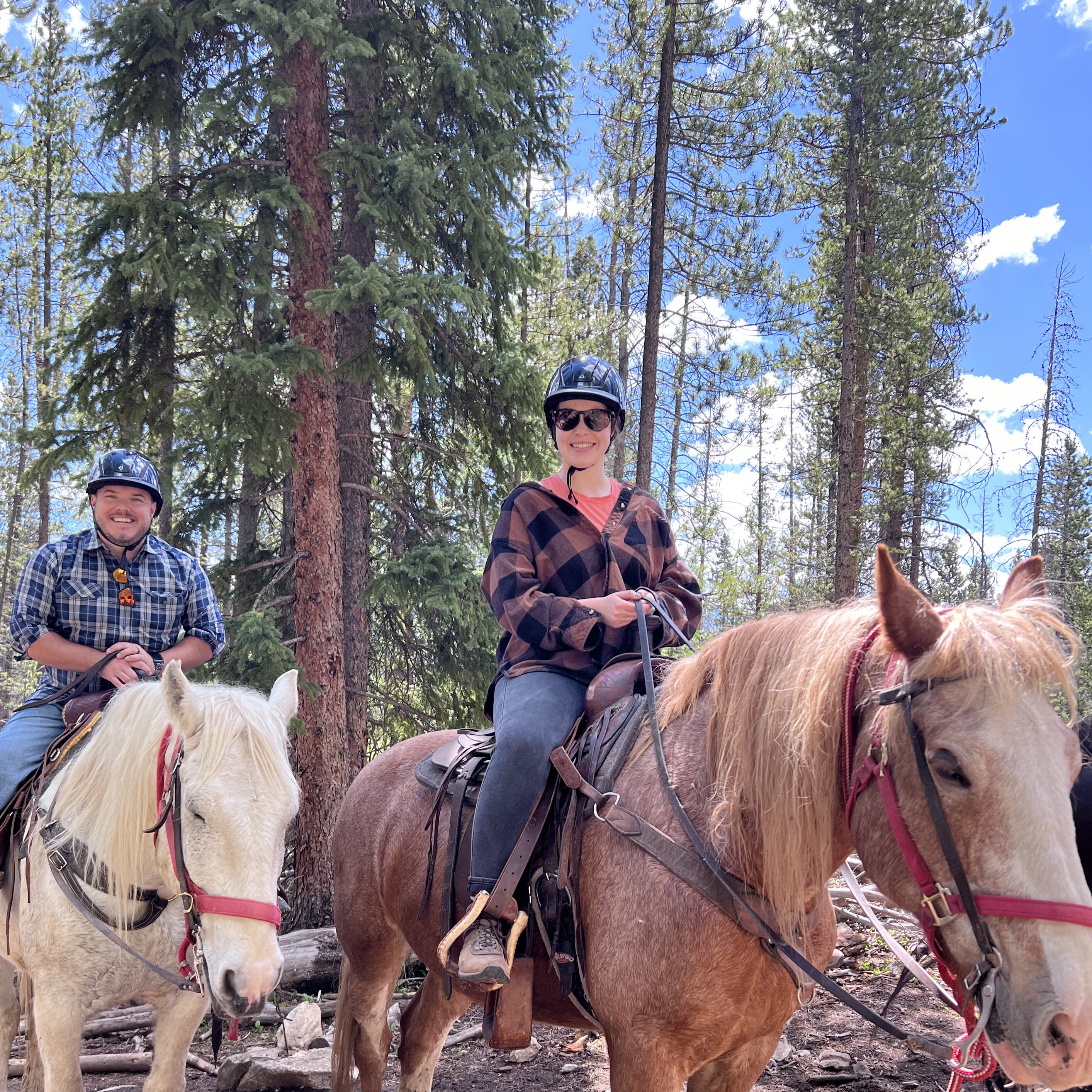 Couple horseback riding through a Colorado mountain forest – turn your adventure memories into custom photo magnets by Spellbound Magnet Co.