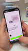 Hands holding a phone showing the Spellbound Magnet Co. mobile ordering page for custom photo magnets – easy online ordering from your smartphone